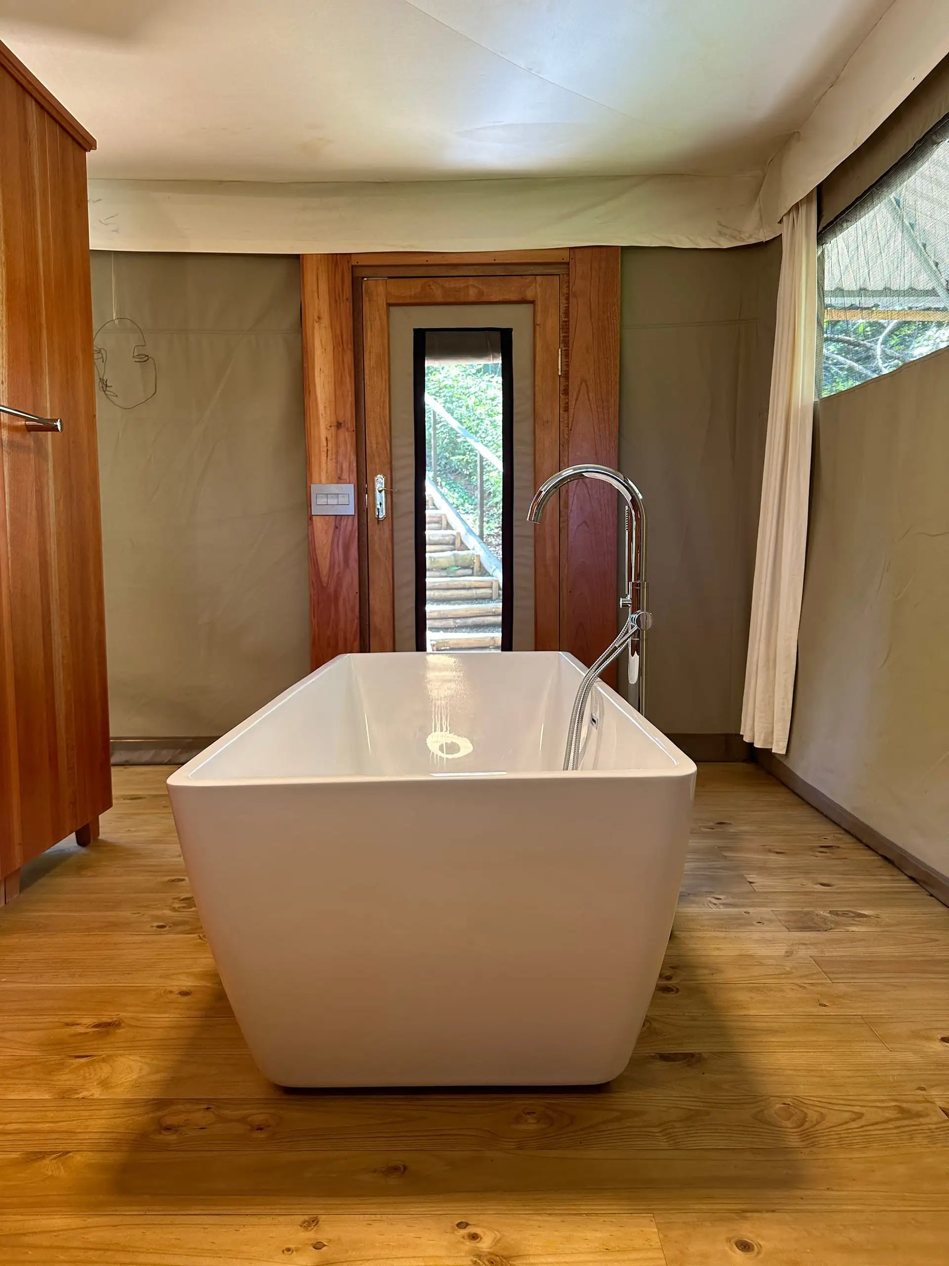 Freestanding bathtub on the pine floor
