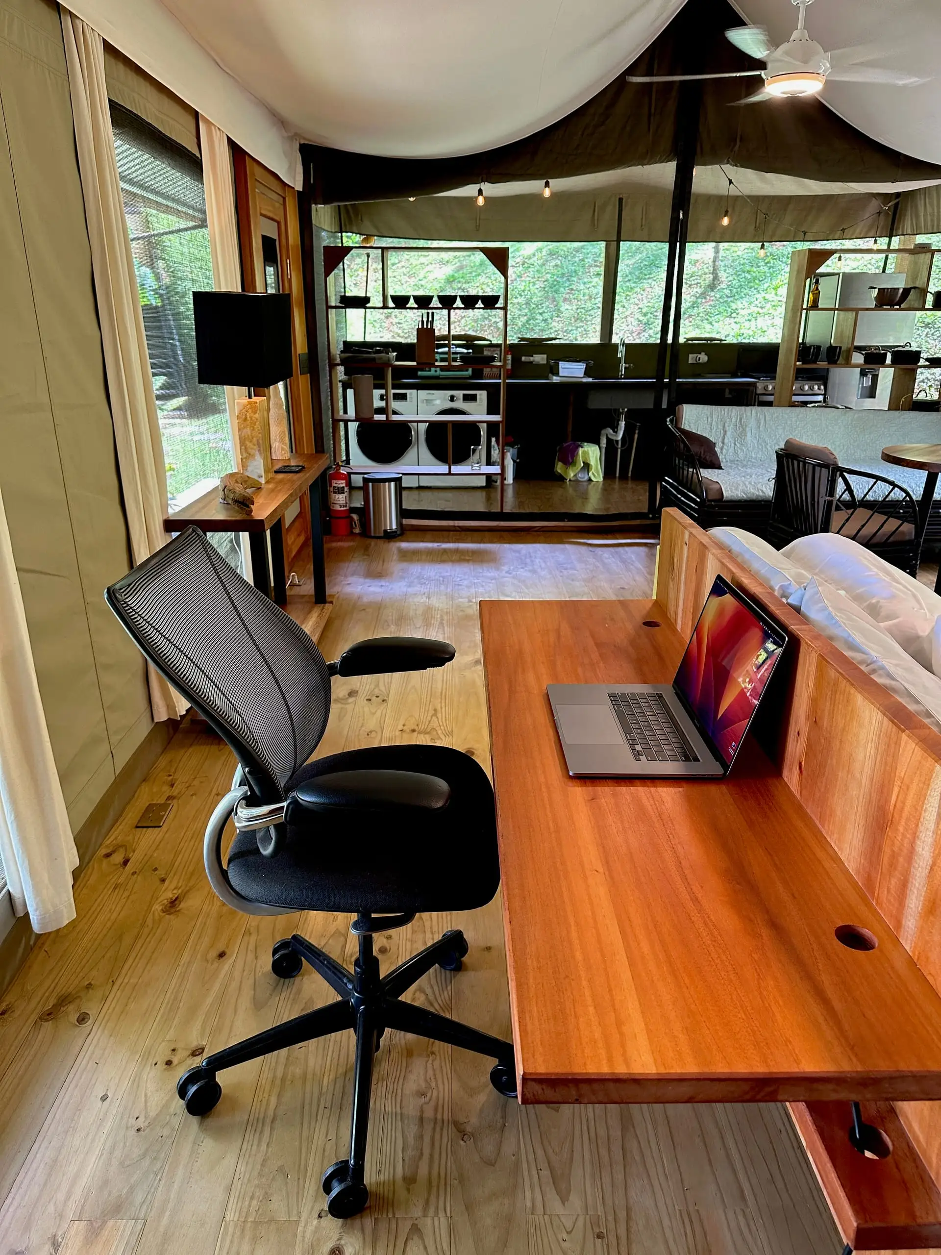 The desk and chair with the forest through the window wall