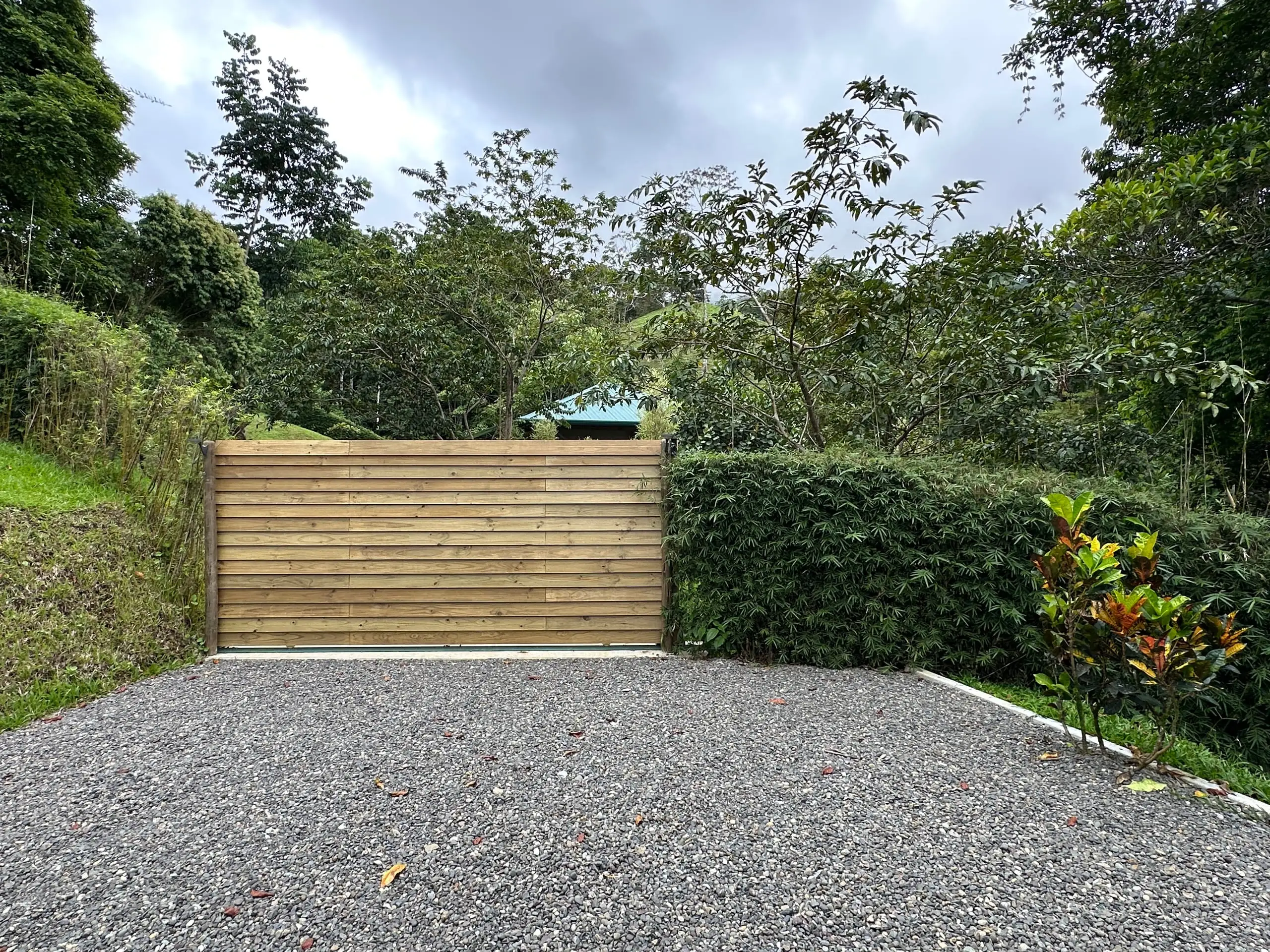 The electric timber gate and gravel drive at the entrance to the tent