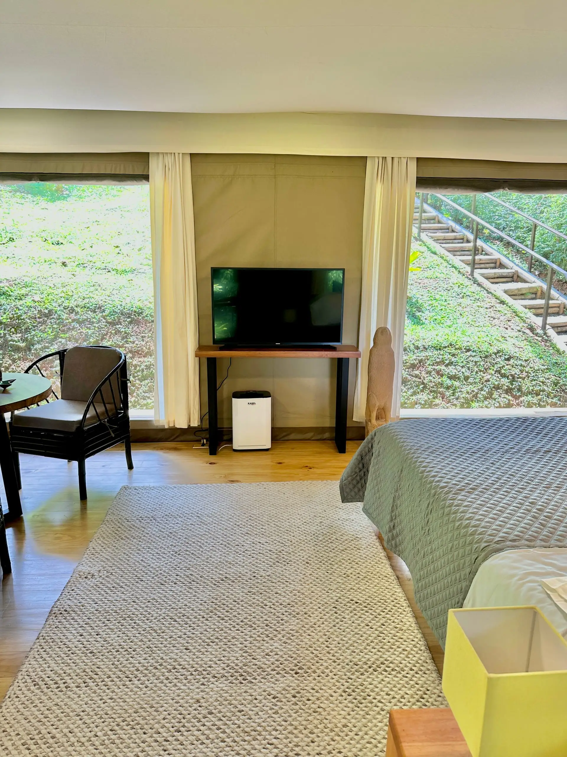 The interior with the canvas walls open to the trees