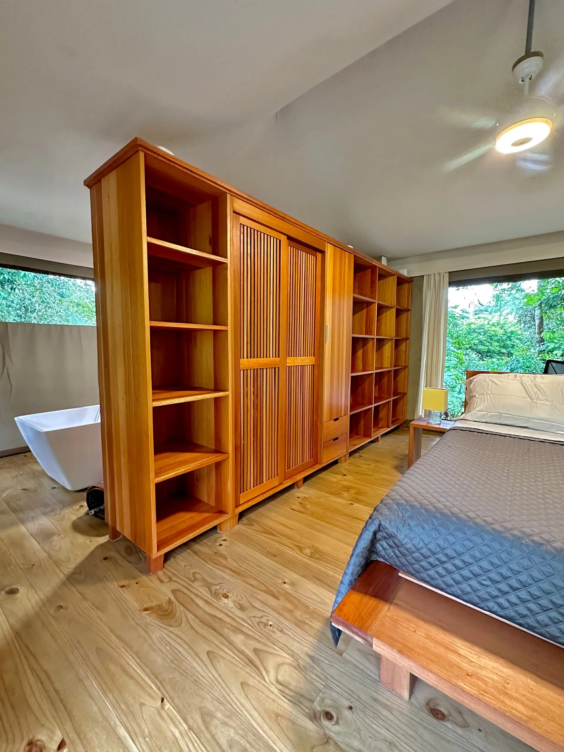Hardwood wardrobe and shelving beside the bed